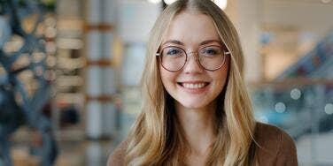 brilliant woman smiling wearing glasses