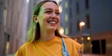 Gen Z woman walking on the street in a big city
