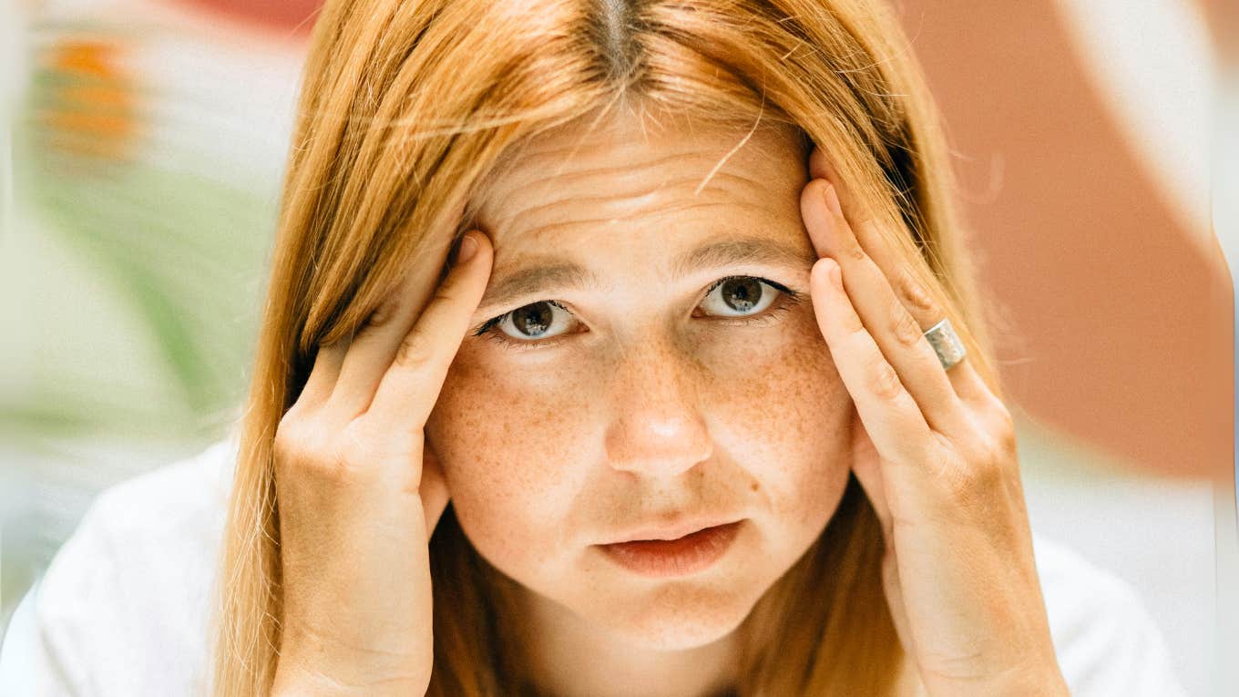 Headache-Inducing Foods That Cause Immense Migraines Woman with an immense migraine.