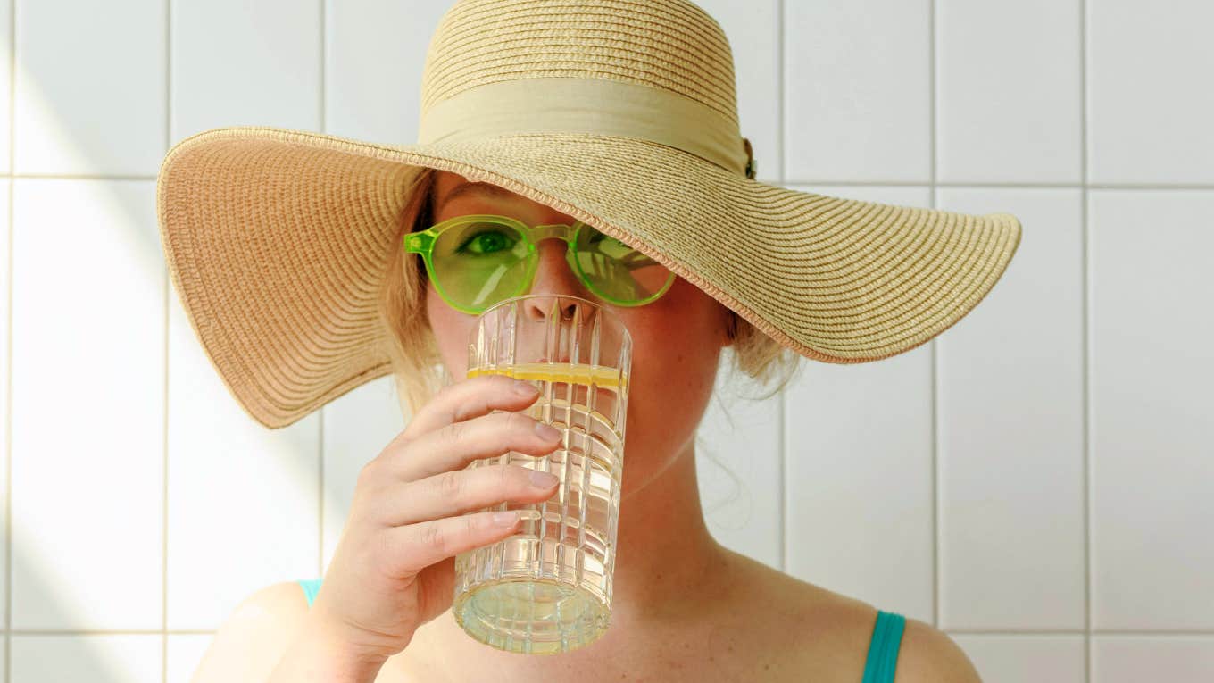 Healthy Reasons You Need To Drink This Surprising Ingredient Daily, According To Research Woman drinking a healthy ingredient daily.