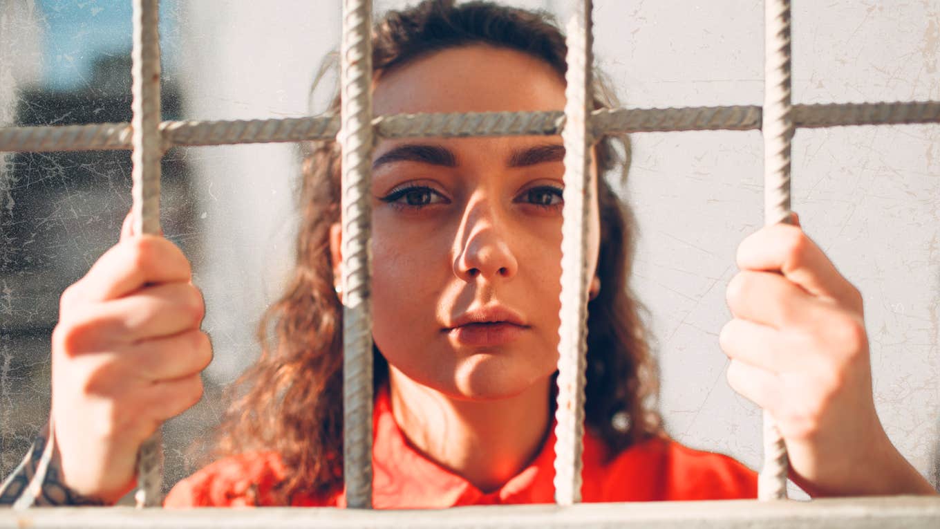 Female behind the bars of jail