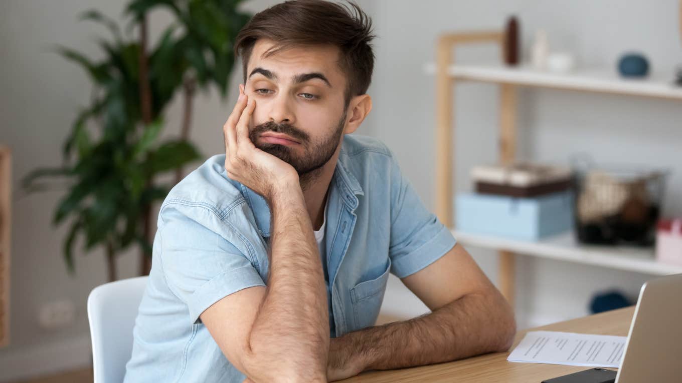 Once-Respected Jobs That Boomers Had But Gen Z Would Never Accept Annoyed Gen Z man looking away from his laptop at his desk.