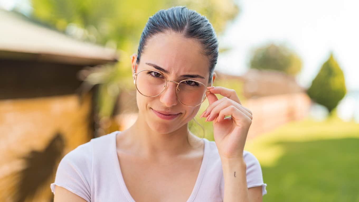 Social Norms That Highly Intelligent People Refuse To Follow intelligent woman touching her glasses